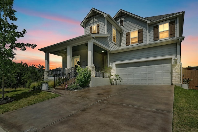 craftsman inspired home with covered porch and a garage