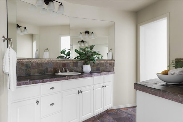 bathroom with vanity and tasteful backsplash