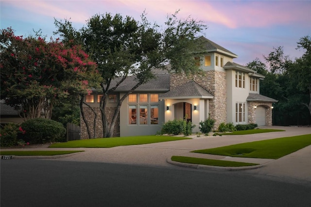 view of front facade with a yard and a garage