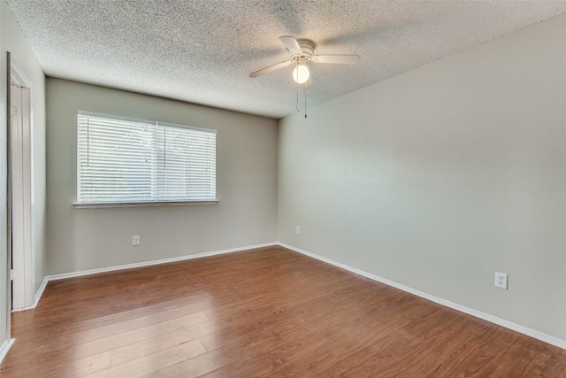 spare room with hardwood / wood-style flooring, a textured ceiling, and ceiling fan