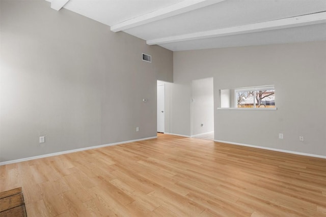 empty room featuring high vaulted ceiling, beam ceiling, and light hardwood / wood-style floors