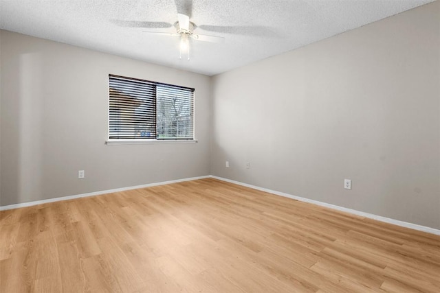 spare room featuring a textured ceiling, ceiling fan, and light hardwood / wood-style flooring