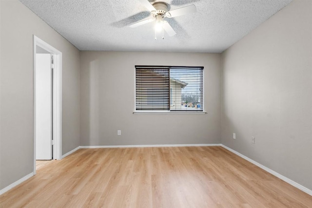 spare room with a textured ceiling, light hardwood / wood-style flooring, and ceiling fan