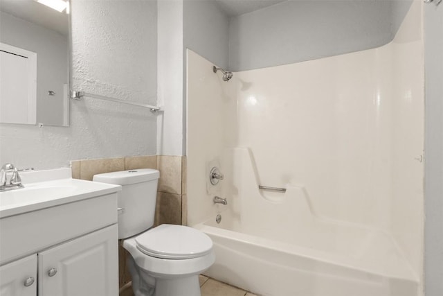 full bathroom featuring tile walls, shower / bath combination, vanity, toilet, and tile patterned floors