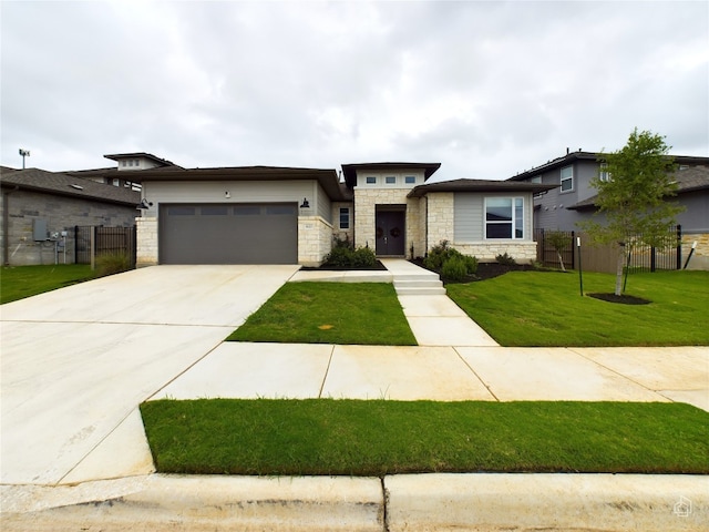 prairie-style home with a front yard and a garage