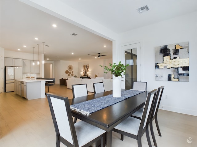 dining room with ceiling fan and light hardwood / wood-style floors