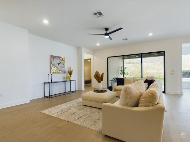 living room featuring ceiling fan and light hardwood / wood-style flooring