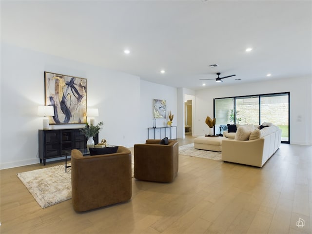 living room featuring ceiling fan and light wood-type flooring