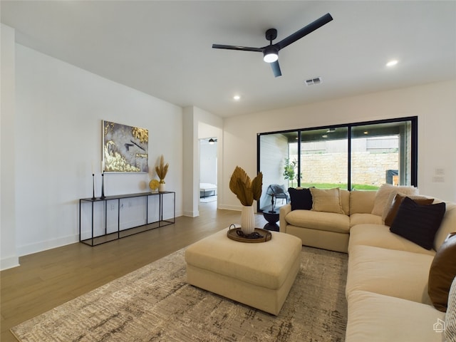 living room featuring ceiling fan and hardwood / wood-style flooring