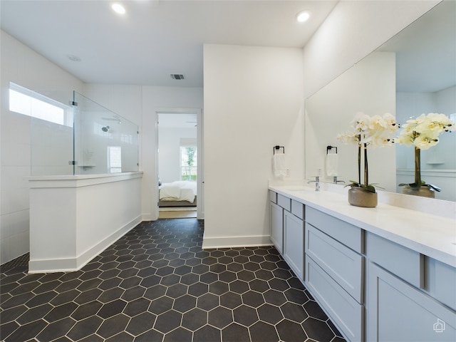 bathroom with vanity, a healthy amount of sunlight, and walk in shower