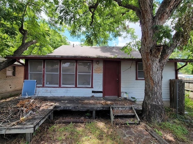 rear view of house featuring a sunroom