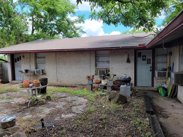 back of house featuring cooling unit