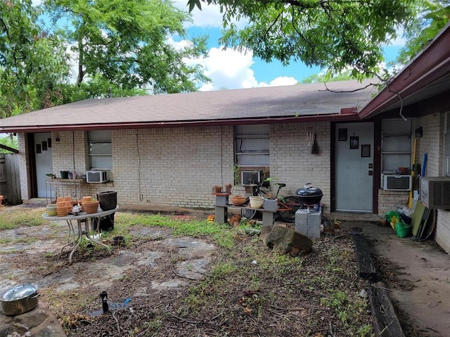 4627 Depew Ave, Austin, TX 78751 - back of property featuring brick siding, cooling unit, and a shingled roof