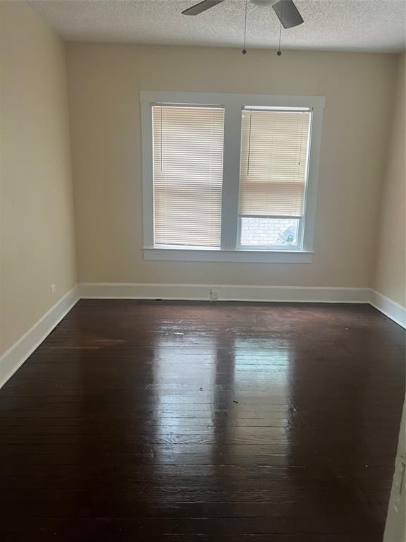 unfurnished room with dark hardwood / wood-style flooring, a textured ceiling, and ceiling fan