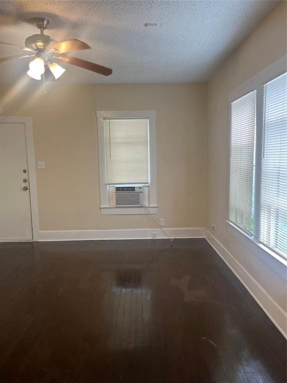 4627 Depew Ave, Austin, TX 78751 - spare room with cooling unit, dark wood-type flooring, a textured ceiling, and a ceiling fan