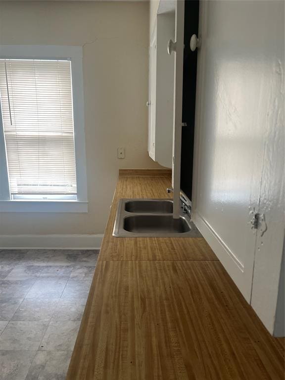 4627 Depew Ave, Austin, TX 78751 - kitchen featuring a sink and baseboards