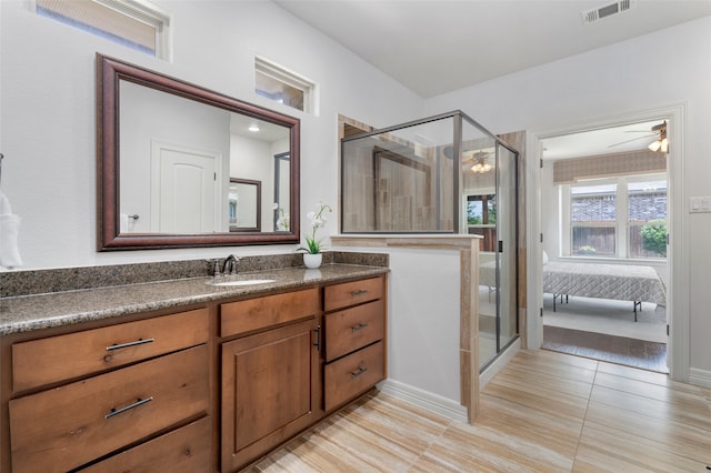 bathroom with walk in shower, vanity, tile patterned floors, and ceiling fan