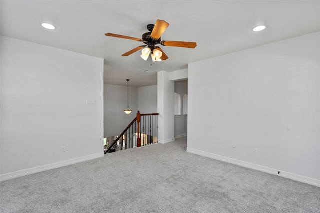 unfurnished room featuring carpet and ceiling fan