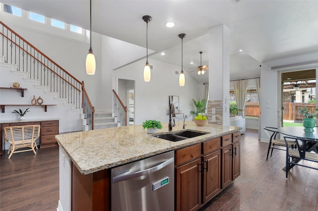 kitchen with stainless steel dishwasher, ceiling fan, sink, hanging light fixtures, and an island with sink