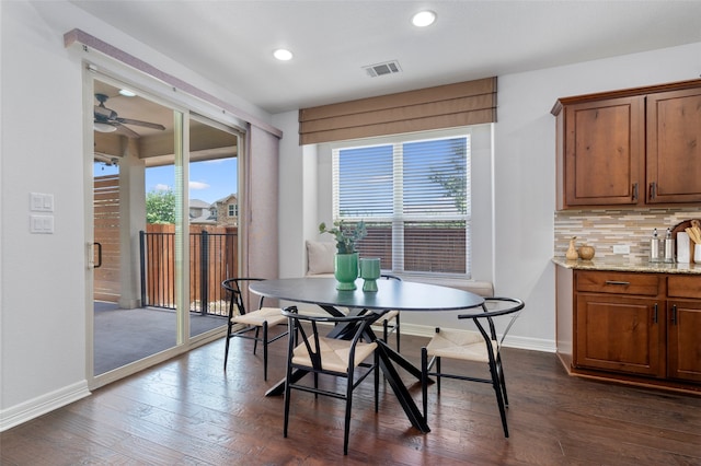 dining space with ceiling fan and dark wood-type flooring