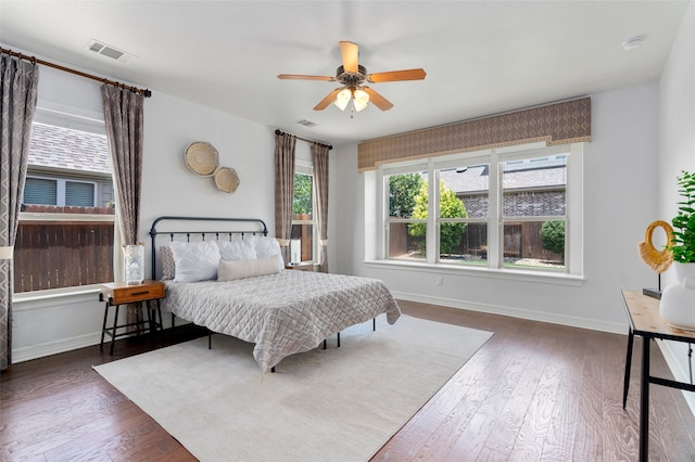 bedroom with ceiling fan and dark hardwood / wood-style flooring