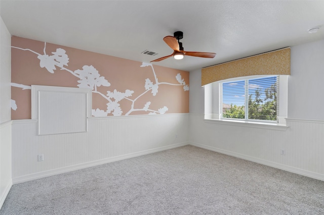 carpeted spare room with ceiling fan