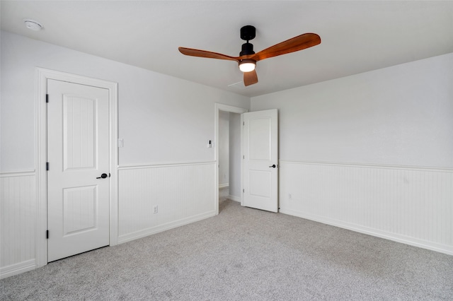 unfurnished bedroom with ceiling fan, a closet, and light carpet