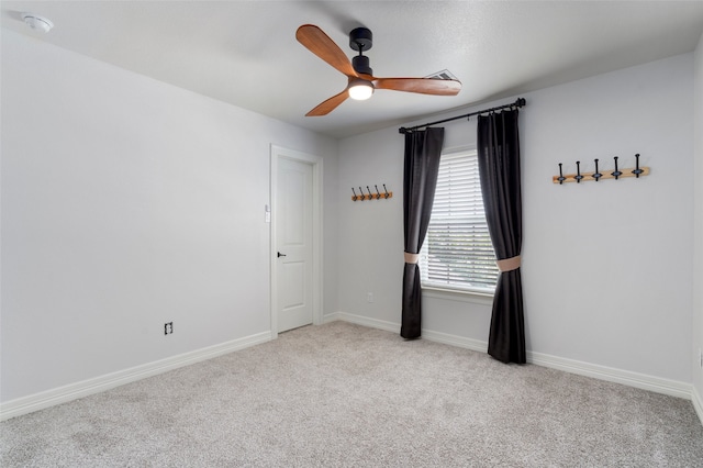 spare room with light carpet and ceiling fan