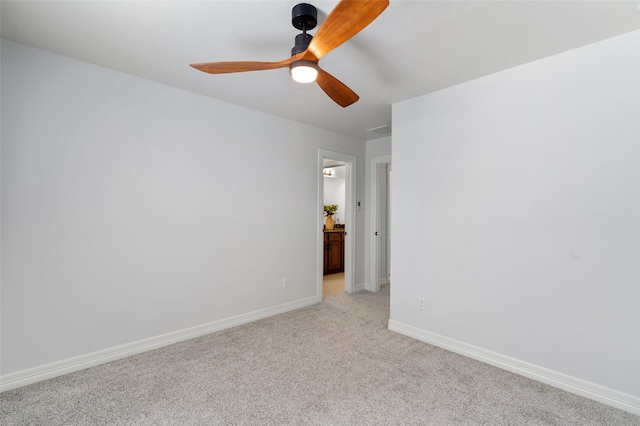 spare room with ceiling fan and light colored carpet