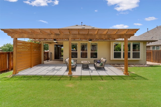 back of house featuring a lawn, a pergola, and a patio