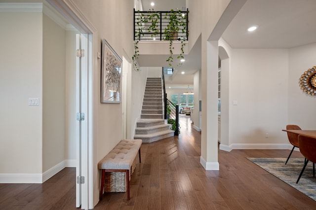 entryway featuring crown molding and dark hardwood / wood-style flooring