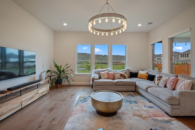 living room with wood-type flooring and a chandelier