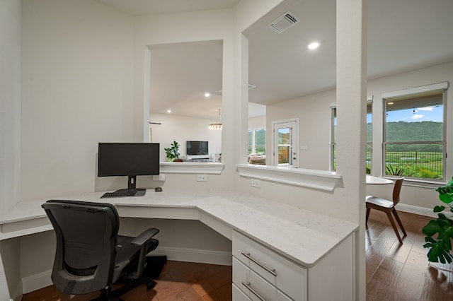 office featuring built in desk, dark hardwood / wood-style floors, and plenty of natural light