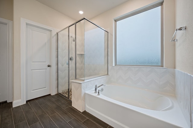 bathroom featuring hardwood / wood-style floors and shower with separate bathtub