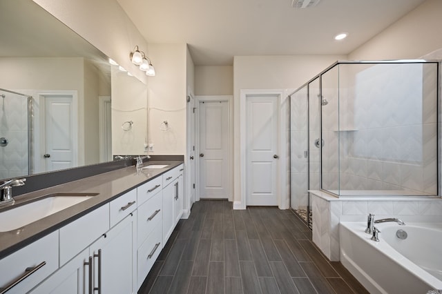 bathroom featuring shower with separate bathtub and vanity