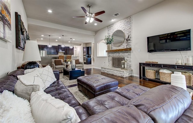 3113 Pasqueflower Pass, Pflugerville, TX 78660 - living area with a ceiling fan, wood finished floors, recessed lighting, a stone fireplace, and baseboards