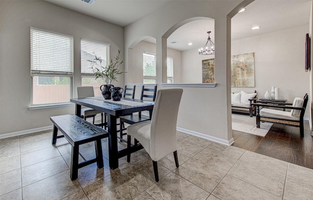 tiled dining area with a notable chandelier