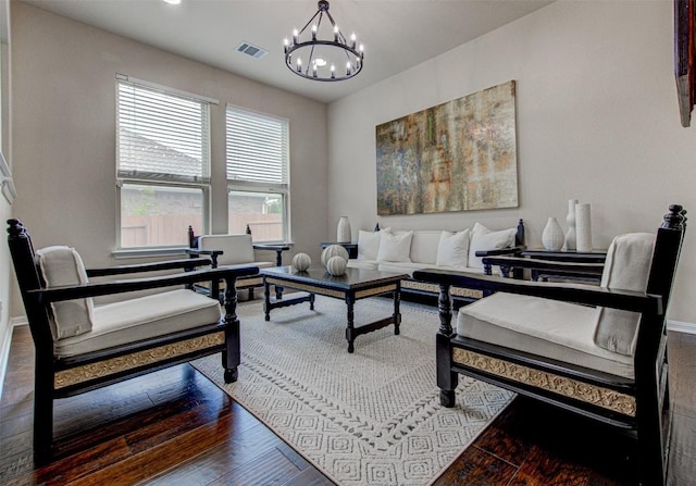 living room featuring hardwood / wood-style flooring and a notable chandelier