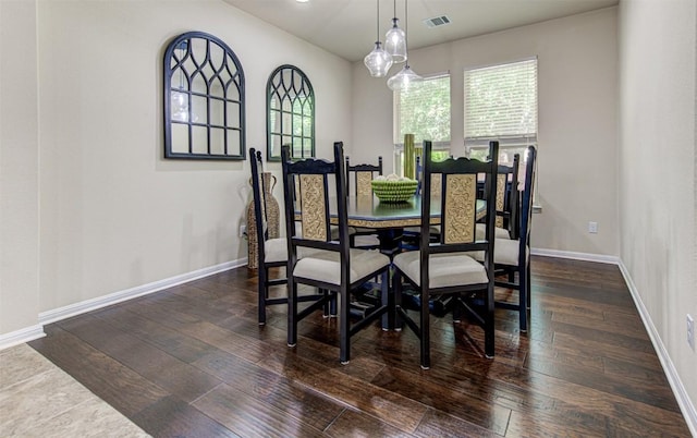 dining area with dark hardwood / wood-style floors