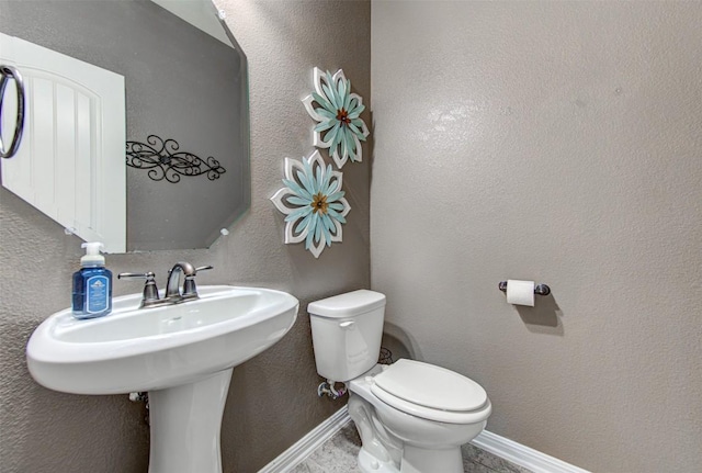 bathroom featuring toilet and sink