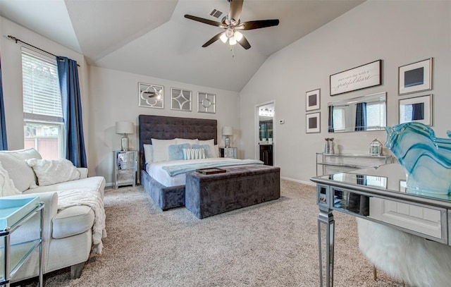 carpeted bedroom featuring ceiling fan, lofted ceiling, and ensuite bath