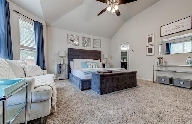 bedroom featuring ensuite bath, ceiling fan, carpet, and vaulted ceiling