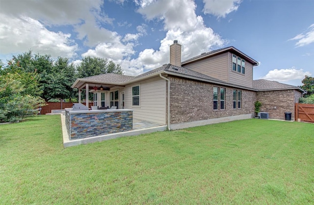 rear view of house featuring a yard, ceiling fan, a patio area, and central air condition unit