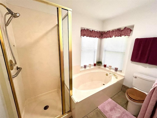 bathroom featuring tile patterned floors, toilet, and independent shower and bath