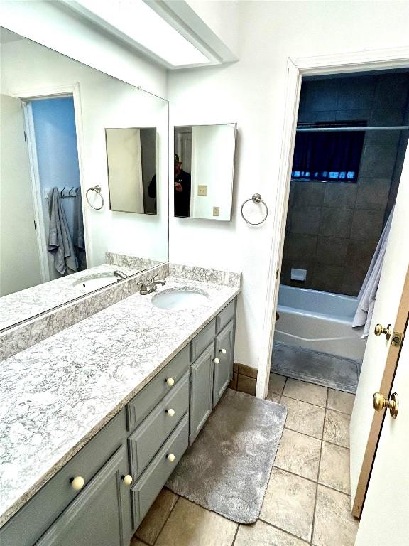 bathroom featuring tile patterned floors, vanity, and tiled shower / bath combo