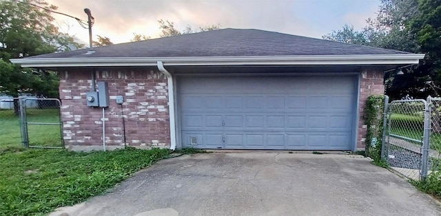 view of garage at dusk