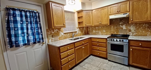 kitchen with gas stove, light tile patterned flooring, sink, and tasteful backsplash