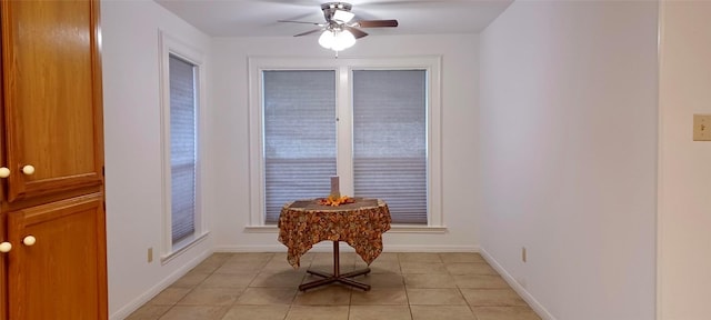 tiled dining area featuring ceiling fan