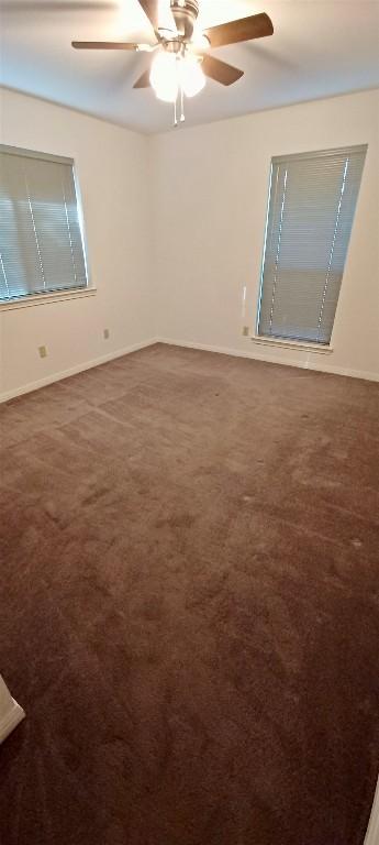 unfurnished room featuring carpet floors and ceiling fan