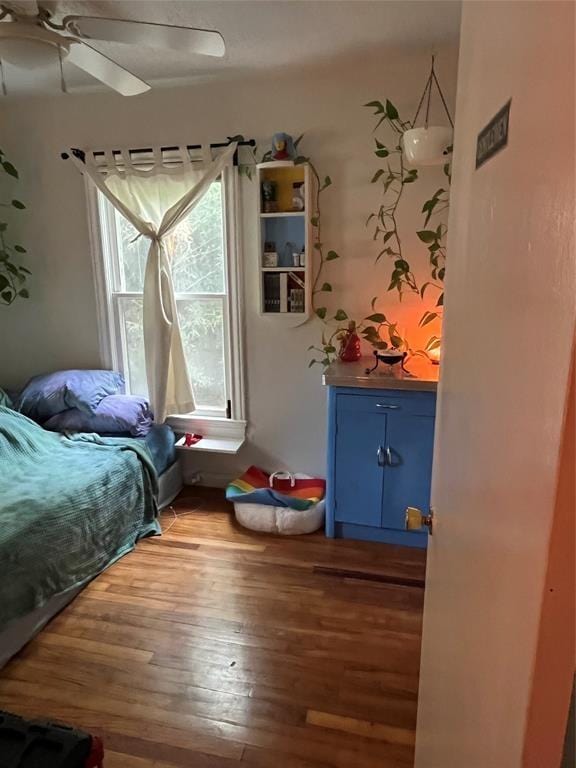 bedroom featuring wood-type flooring and ceiling fan